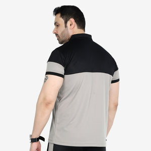 Man wearing a black and gray polo shirt on a white background